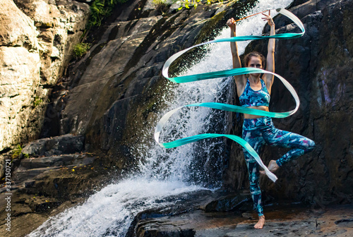 Rhythmic gymnastics ribbon practice next to the waterfall