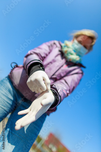 A german woman with a mouth protector and gloves