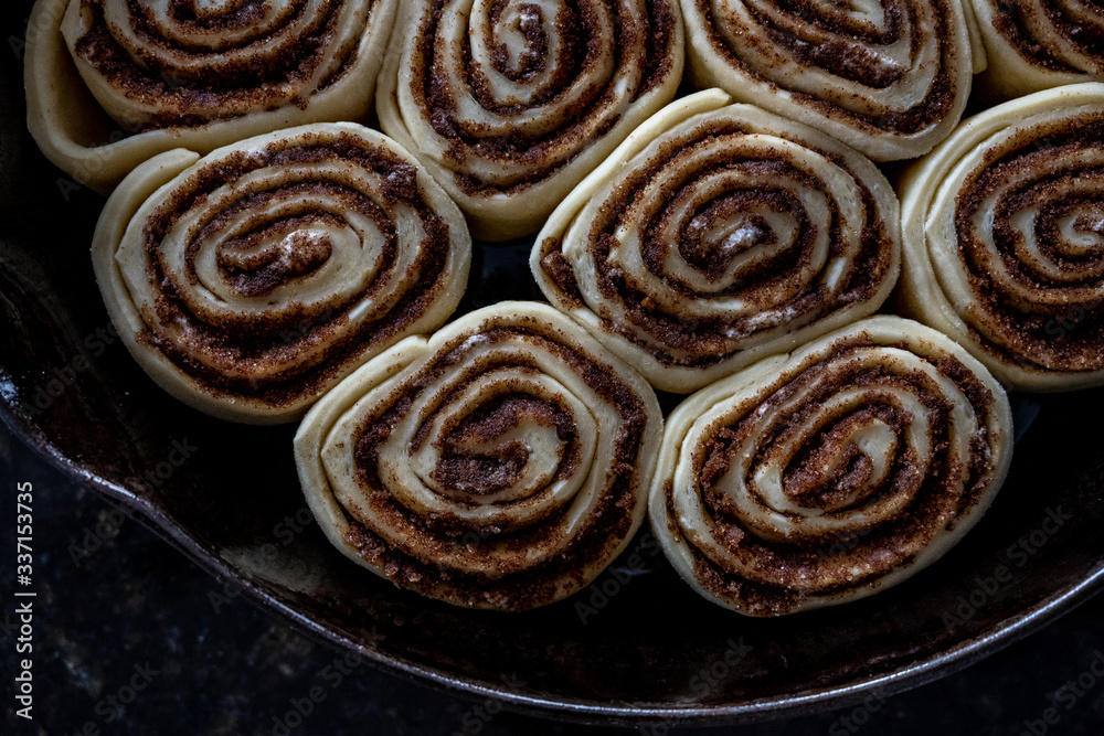 Cinnamon Rolls Rise at the Edge of Pan