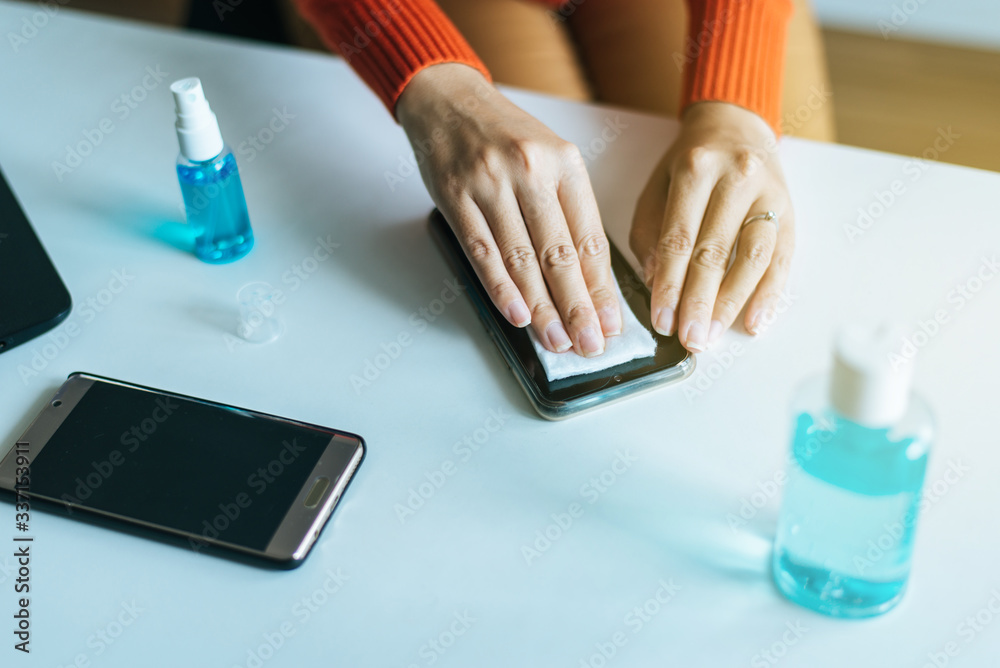 Fototapeta premium Cleaning dirty mobile phone on screen,Preventive measures against coronavirus,Covid-19
