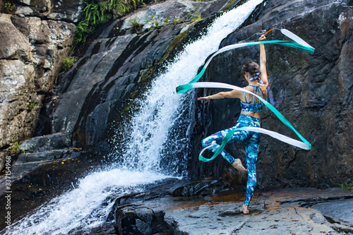 Rhythmic gymnastics ribbon practice next to the waterfall