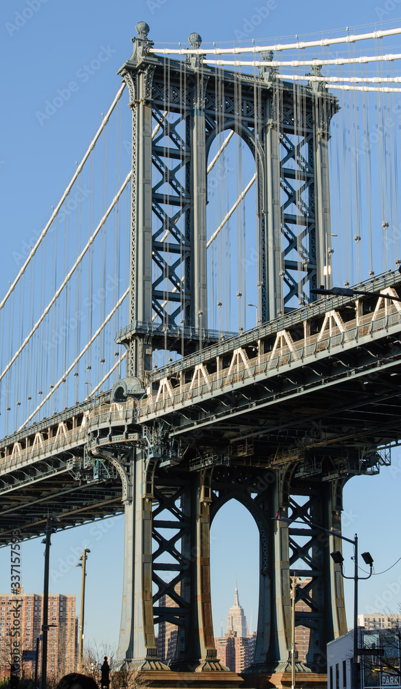 Fototapeta premium Manhattan Bridge with Empire State Building in the distance.