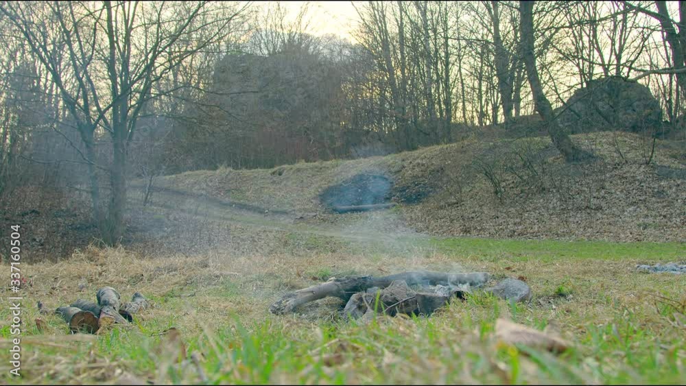 Smoke from a small campfire that had gone out. A clearing without people and a fire that is burning down. Tourist place without people. Smoke from a small campfire that had gone out. A clearing without people and a fire that is burning down. Tourist place without people.