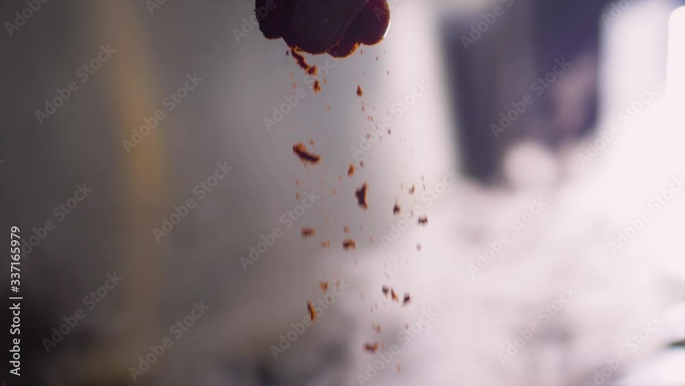 Cook adding spices to food