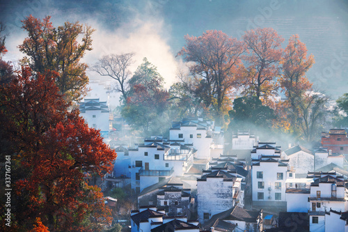 The morning fog on the dwellings of Anhui buildings in Wuyuan county Jiangxi province, China. photo