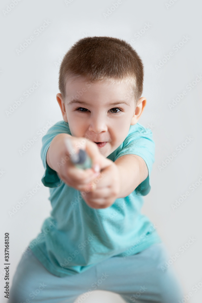 a small boy in doctor's clothes holds a syringe a small boy in doctor's clothes holds a syringe