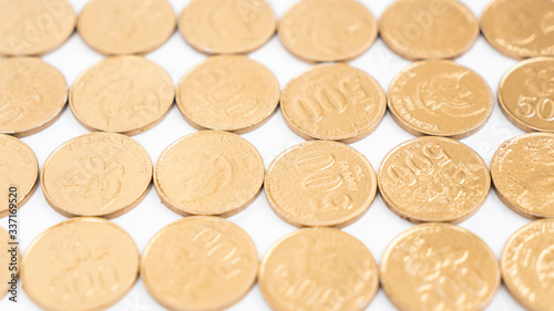 Closeup of gold coins row on white background
