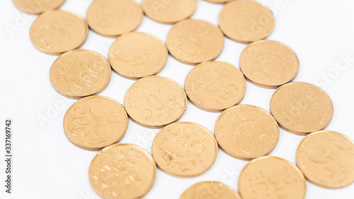 Closeup of golden coins on white background
