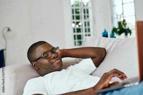 man relaxing on sofa
