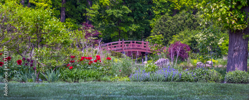 Arched bridge in a beautiful garden during a colorful summer season