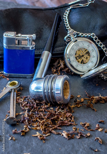 Wallpaper Mural Aristicob pipe still life on slate background, with a flint lighter, tobacco and a silver pocket watch  Torontodigital.ca