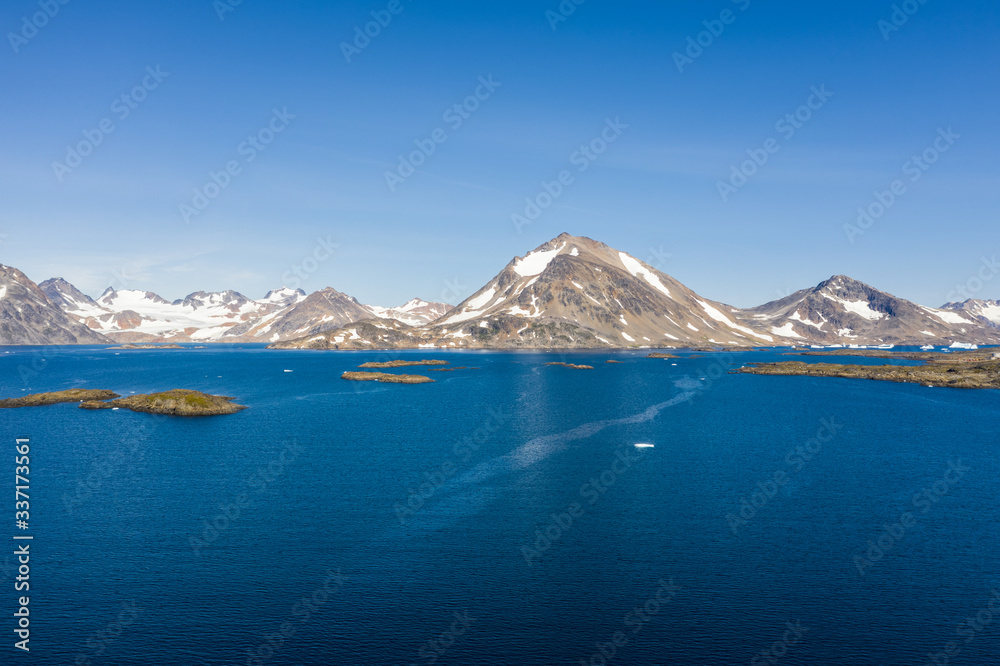 A beautiful blue sea, surrounded by mountains. 