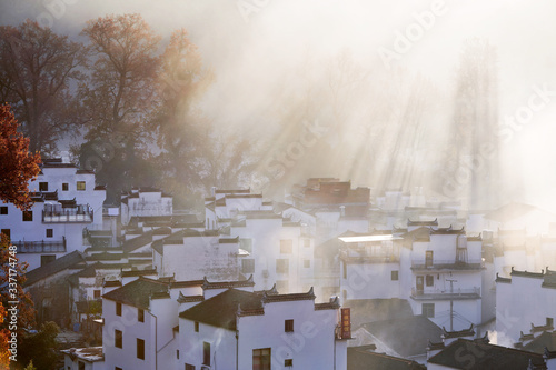 The morning fog on the dwellings of Anhui buildings in Wuyuan county Jiangxi province, China. photo