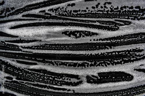 White foam bubbles on a black background