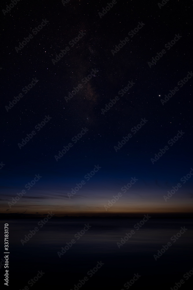 Vertical image of The sky with star at the lake in the twilight sky
