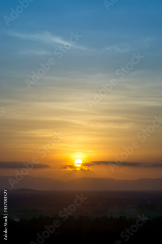 Sunset sky with clouds above the mountain.