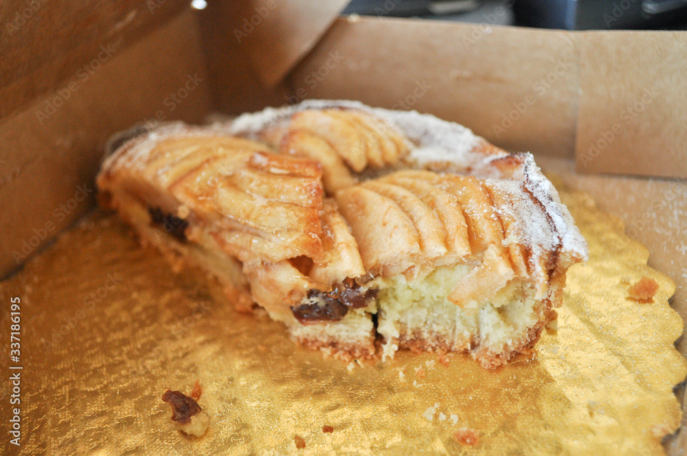 Apple pie cut in half in a golden take away box Apple pie cut in half in a golden take away box