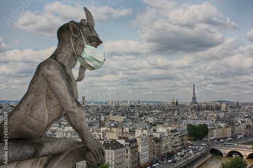 Coronavirus COVID-19. Gargoyles of Notre Dame with medical masks.