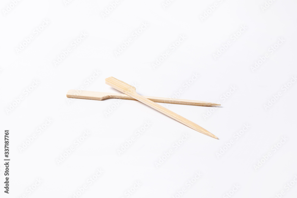 Convenient disposable wooden skewers for food and canapes on a white background Convenient disposable wooden skewers for food and canapes on a white background