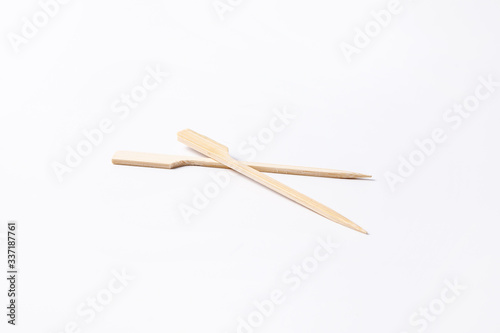 Convenient disposable wooden skewers for food and canapes on a white background