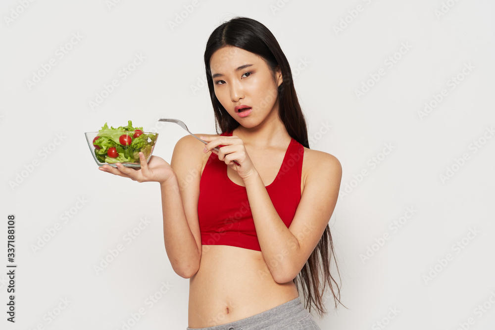 young woman holding a salad