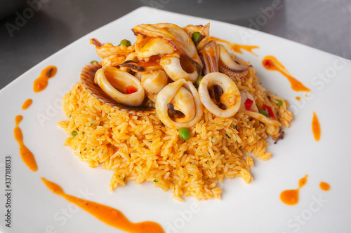 Φωτογραφία Peruvian food: arroz con mariscos or rice with seafood decorated with squid and