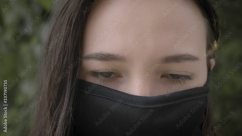 Close-up portrait of a brunette in a protective medical mask on her face. The epidemic of influenza virus and coronavirus. Close-up portrait of a brunette in a protective medical mask on her face. The epidemic of influenza virus and coronavirus.
