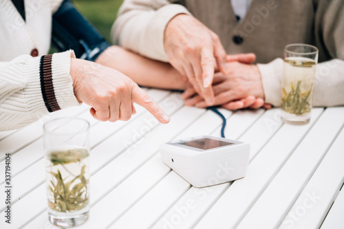 Asian aged couple measuring blood pressure photo