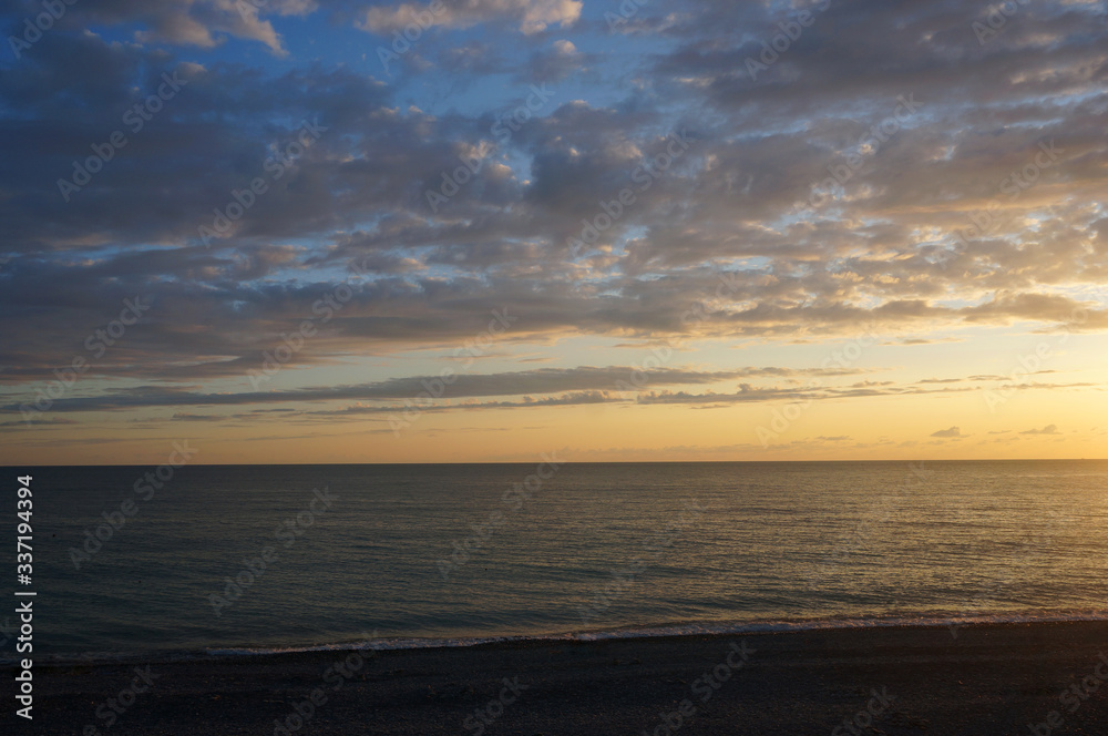 Landscape with sunset on the sea coast