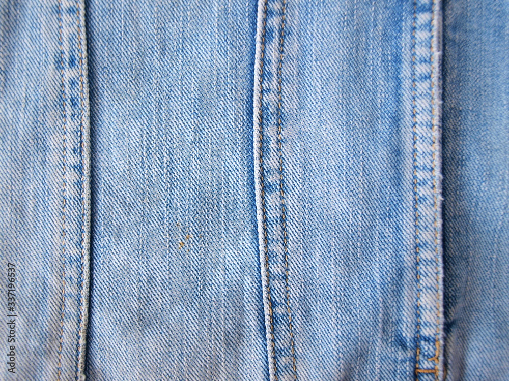 Blue denim fabric seam, texture background, textile, seam close up. Blue denim fabric seam, texture background, textile, seam close up.