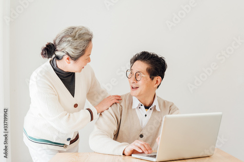 Asian aged couple using a laptop photo