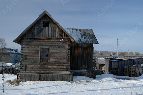 an old wooden abandoned house in a rural area in the North of Russia