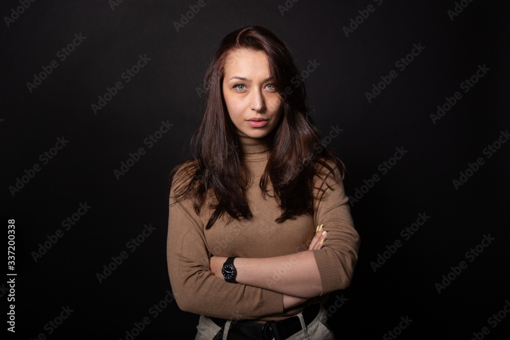 Beautiful woman with arm crossed and seriously looking at camera. Human portrait Beautiful woman with arm crossed and seriously looking at camera. Human portrait