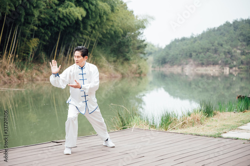 Asian aged man tai chi at the lake