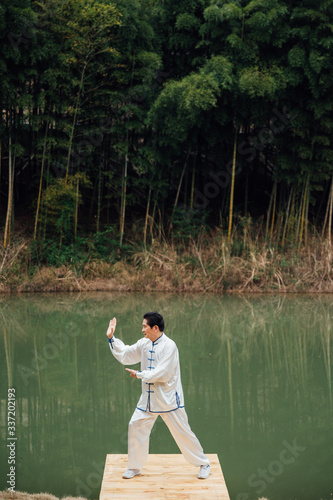 Asian aged man tai chi at the lake