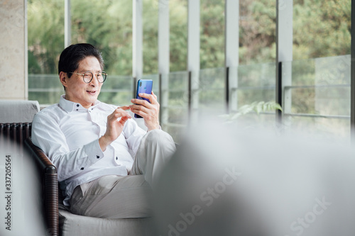 Asia-aged man use smartphones photo