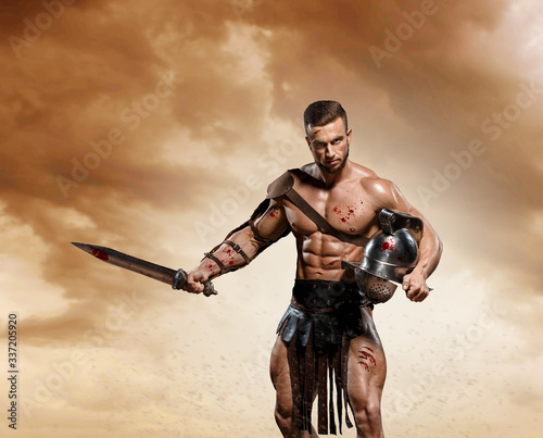 Gladiator fighting on the arena of the Colosseum on dramatic light. Roman Hoplomachus armed fighter Concept historical photo photo
