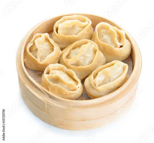 Steamer with oriental dumplings on white background photo