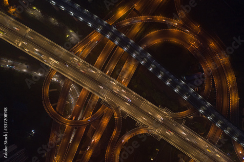 Aerial overhead shot of flyover highway traffic before dawn in Chongqing, China photo