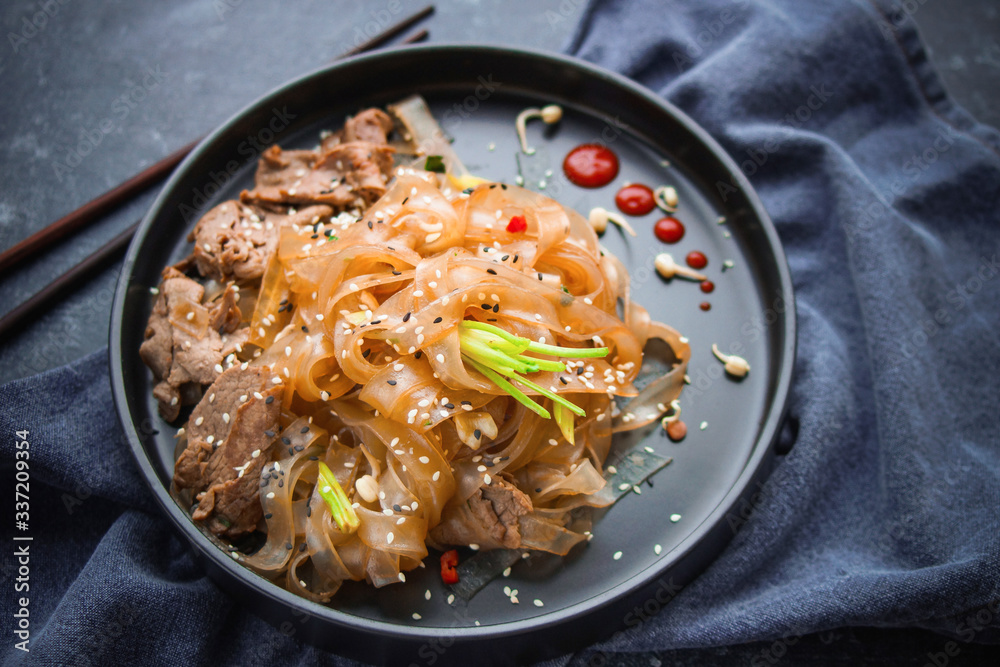 Asian Cuisine, Spicy Asian Beef Noodles on dark background Asian Cuisine, Spicy Asian Beef Noodles on dark background