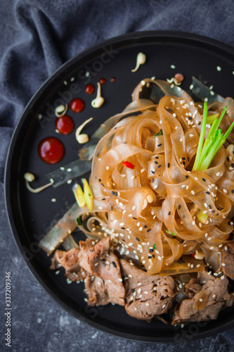Asian Cuisine, Spicy Asian Beef Noodles on dark background