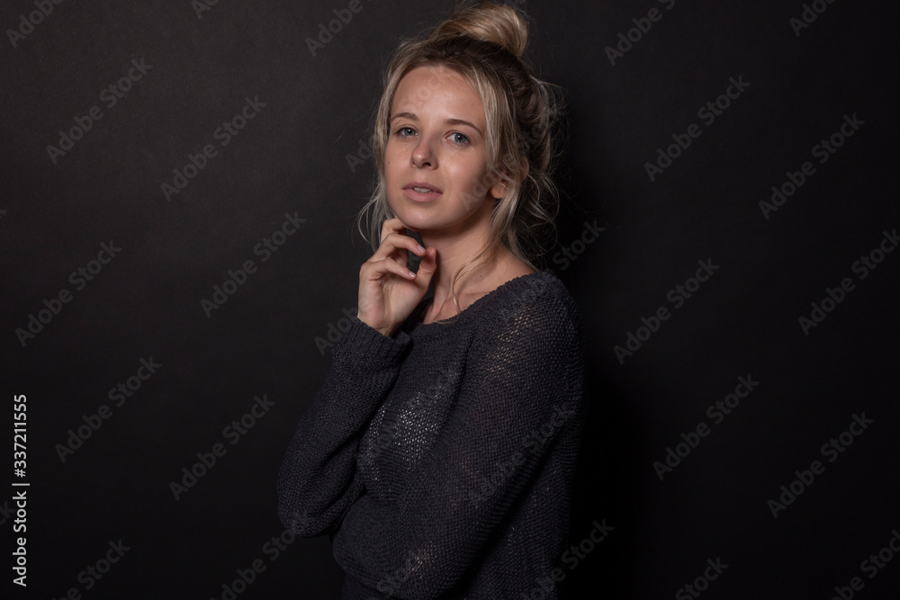 Young woman posing for photoshoot. Isolated on black background Young woman posing for photoshoot. Isolated on black background