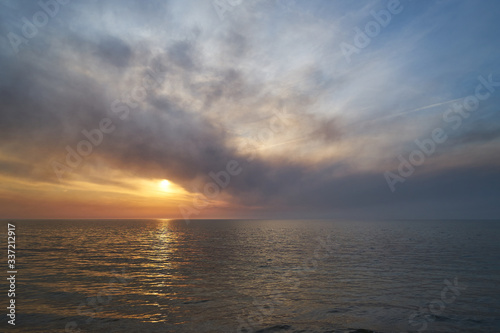 Sea sunset. Smoke wildfires sweeping across the sky. © PhotoBetulo