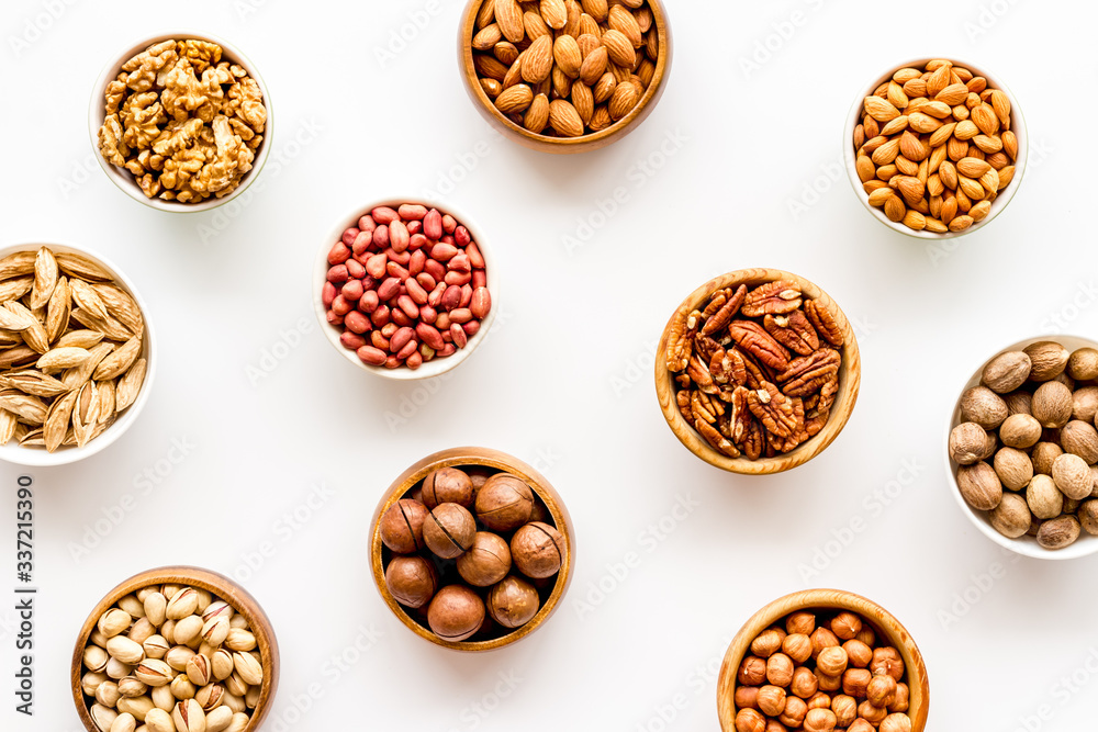 Set of macadamia, hazelnut, walnut, almond, pistachio, pecans nuts on white background top-down pattern Set of macadamia, hazelnut, walnut, almond, pistachio, pecans nuts on white background top-down pattern