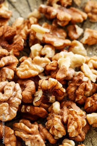 Walnuts on brown wooden background.