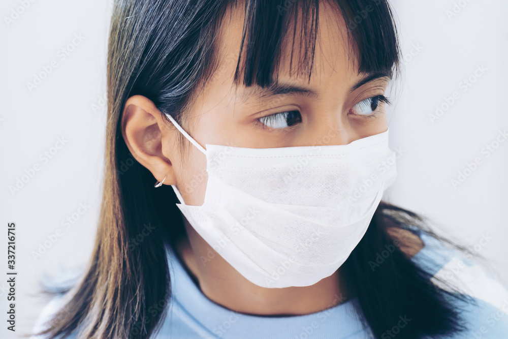 Girl under face mask covering mouth and nose. Corona Virus or COVID-19 concept. Girl under face mask covering mouth and nose. Corona Virus or COVID-19 concept.