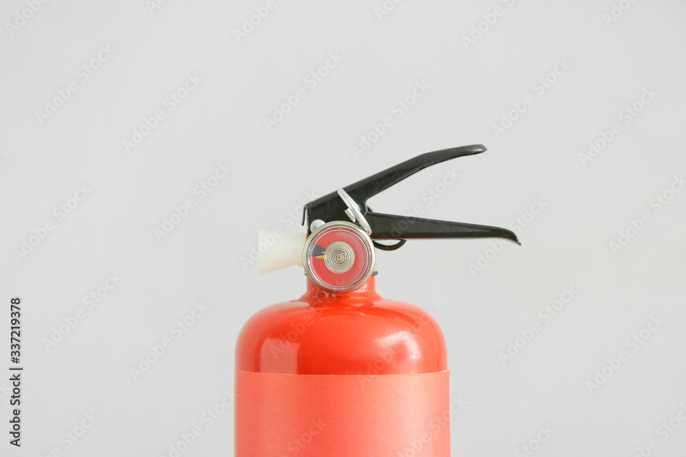 Fire extinguisher on grey background Fire extinguisher on grey background