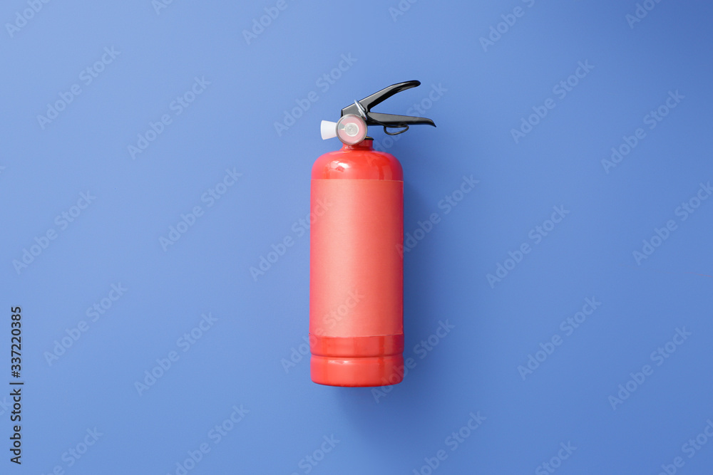 Obraz premium Fire extinguisher on color background