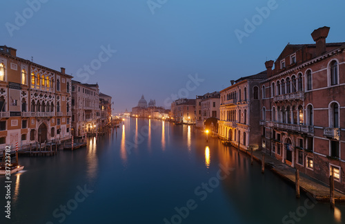 VENICE, ITALY - February 17, 2020: Foggy morning at Grand Canal and in the background the Basilica Santa Maria della Salute,view from Ponte dell' Accademia bridge 