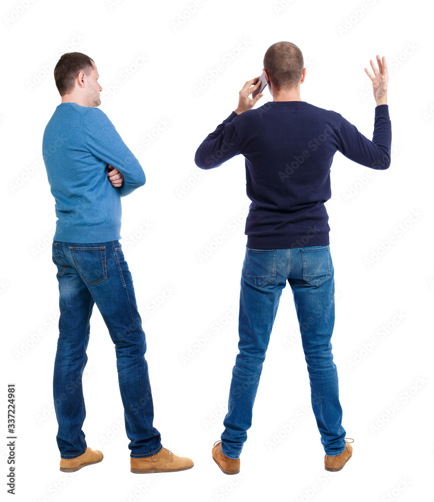 Back view of two man in sweater with mobile phone.